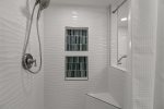 Master shower with scalloped tile walls